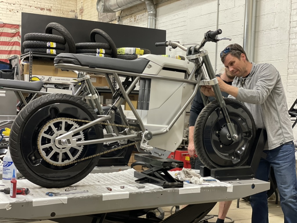 LAND Labs team assembling an electric motorcycle prototype