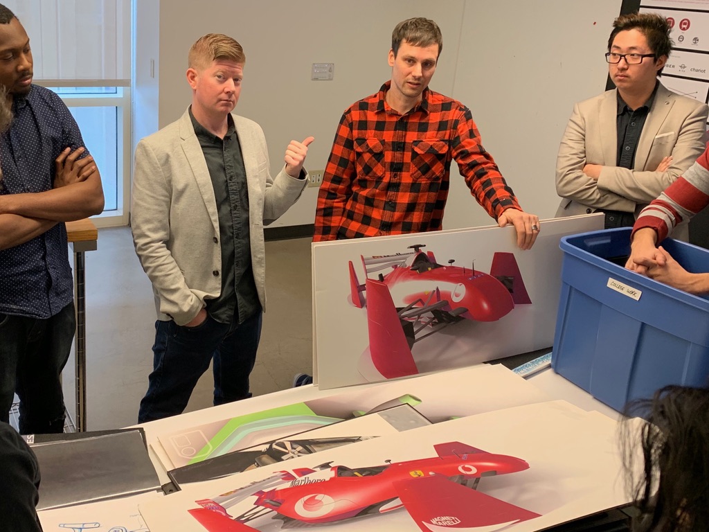 Scott and Zack critiquing student Formula 1 concept renders